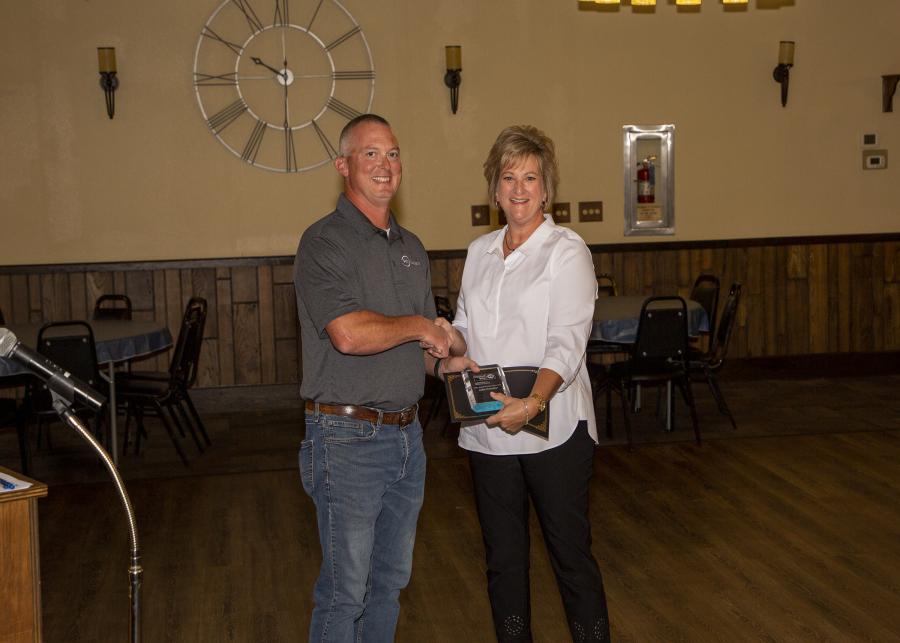 Todd Friend presenting Julie Oxender with Board Member of the Year Award